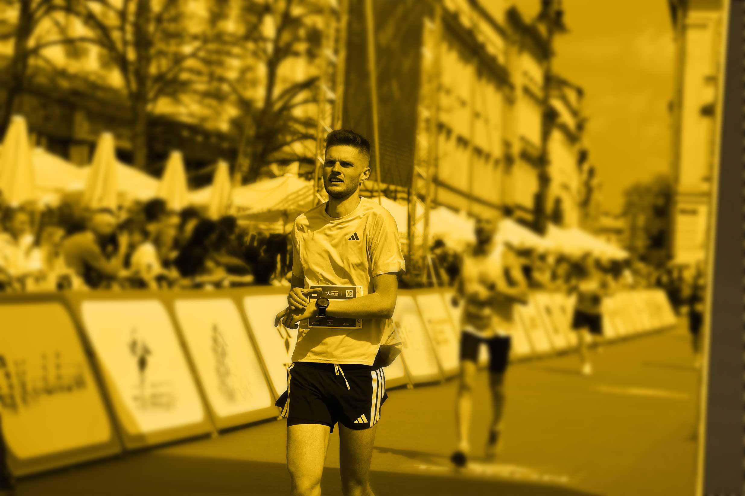 Splitshape's founder stopping his watch as he crosses a marathon finish line